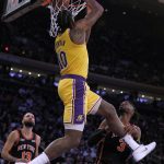 
              Los Angeles Lakers center DeAndre Jordan (10) goes to the hoop for a reverse dunk against New York Knicks center Nerlens Noel (3) and guard Evan Fournier (13) during the first half of an NBA basketball game Tuesday, Nov. 23, 2021, in New York. (AP Photo/Jim McIsaac)
            