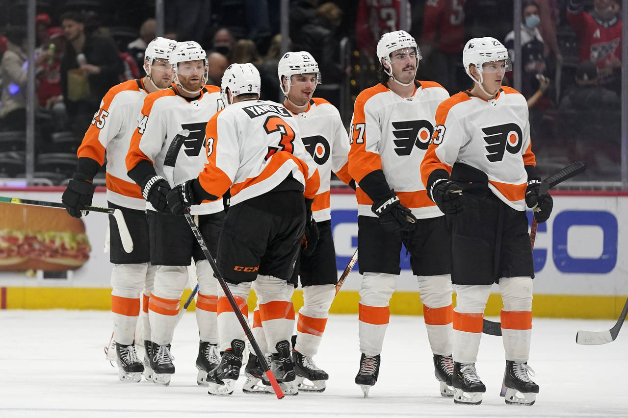 Members of the Philadelphia Flyers celebrate after an NHL hockey game against the Washington Capita...