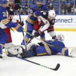 
              Buffalo Sabres goaltender Dustin Tokarski (31) lies on the ice after blocking a shot by Columbus Blue Jackets center Boone Jenner (38) during the first period of an NHL hockey game Monday, Nov. 22, 2021, in Buffalo, N.Y. (AP Photo/Joshua Bessex)
            