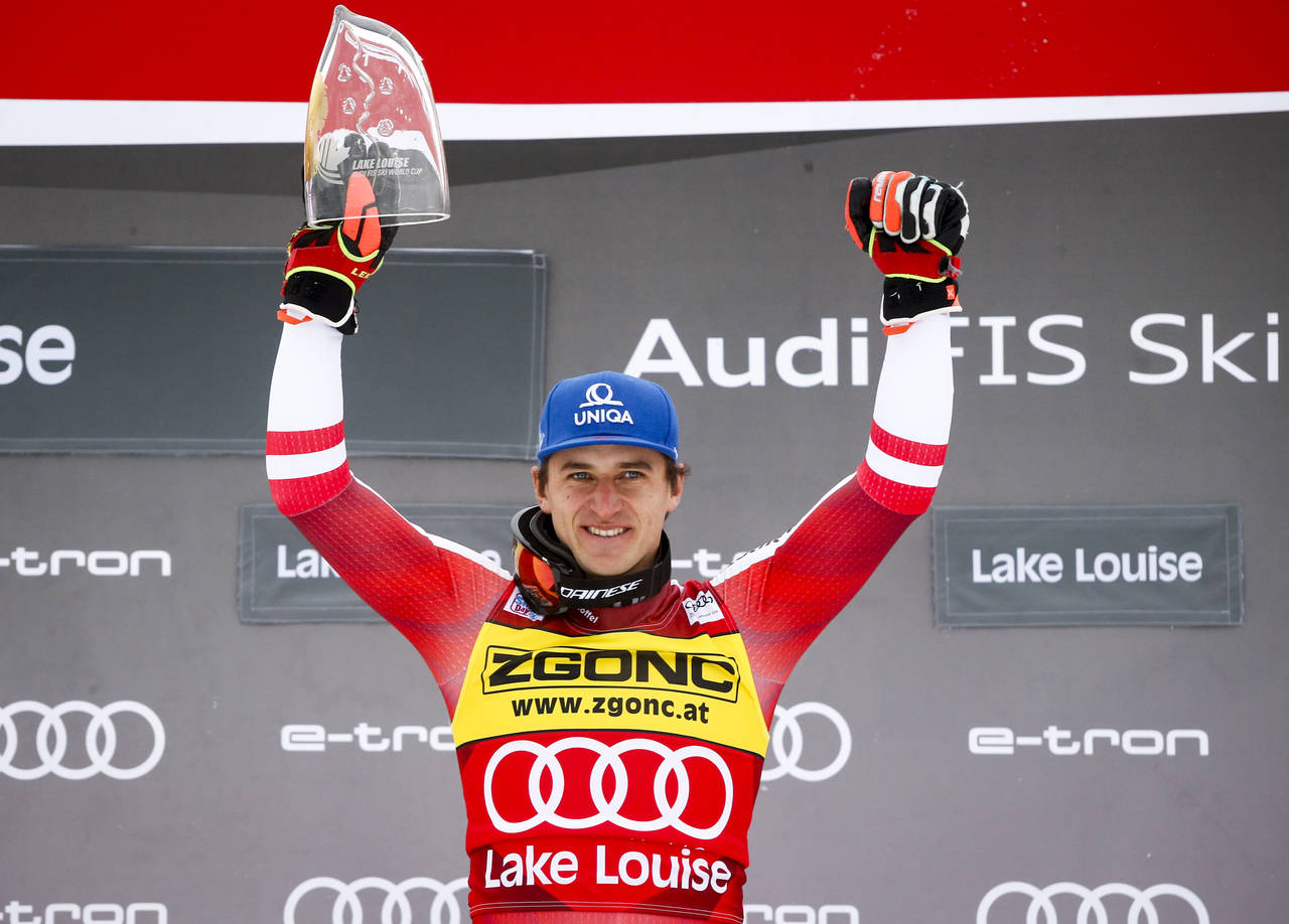 Austria's Matthias Mayer celebrates on the podium after winning the men's World Cup downhill ski ra...