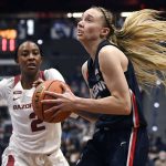 
              Connecticut's Paige Bueckers drives past Arkansas' Samara Spencer (2) in the second half of an NCAA college basketball game, Sunday, Nov. 14, 2021, in Hartford, Conn. (AP Photo/Jessica Hill)
            