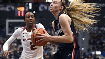 Connecticut's Paige Bueckers drives past Arkansas' Samara Spencer (2) in the second half of an NCAA...