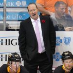 
              Pittsburgh Penguins assistant coach Todd Reirden stands behind the bench during the first period of the team's NHL hockey game against the Philadelphia Flyers in Pittsburgh, Thursday, Nov. 4, 2021. Reirden was filling in for coach Mike Sullivan, who tested positive for COVID-19. (AP Photo/Gene J. Puskar)
            