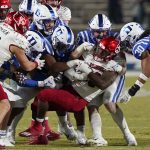 
              Louisville running back Maurice Burkley is tackled by Duke defensive players during the second half of an NCAA college football game in Durham, N.C., Thursday, Nov. 18, 2021. (AP Photo/Gerry Broome)
            