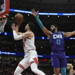 
              Chicago Bulls guard Zach LaVine (8) goes up for a shot against Charlotte Hornets forward Miles Bridges (0) during the first half of a NBA basketball game Monday, Nov. 29, 2021 in Chicago. (AP Photo/Paul Beaty)
            