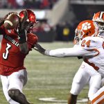 
              Louisville quarterback Malik Cunningham (3) avoids the grasp of Clemson safety Nolan Turner (24) during the second half of an NCAA college football game in Louisville, Ky., Saturday, Nov. 6, 2021. (AP Photo/Timothy D. Easley)
            