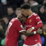 
              Manchester United's Jadon Sancho celebrates with Manchester United's Fred, left, after scoring the opening goal during the English Premier League soccer match between Chelsea and Manchester United at Stamford Bridge stadium in London, Sunday, Nov. 28, 2021. (AP Photo/Kirsty Wigglesworth)
            