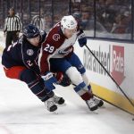 
              Colorado Avalanche forward Nathan MacKinnon, right, controls the puck in front of Columbus Blue Jackets defenseman Andrew Peeke during the first period of an NHL hockey game in Columbus, Ohio, Saturday, Nov. 6, 2021. (AP Photo/Paul Vernon)
            