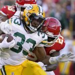 
              Green Bay Packers running back Aaron Jones (33) runs with the ball as Kansas City Chiefs cornerback Mike Hughes (21) defends during the first half of an NFL football game Sunday, Nov. 7, 2021, in Kansas City, Mo. (AP Photo/Ed Zurga)
            