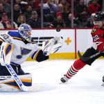 
              St. Louis Blues goaltender Jordan Binnington, left, makes a save on a shot against Chicago Blackhawks center Ryan Carpenter during the first period of an NHL hockey game in Chicago, Friday, Nov. 26, 2021. (AP Photo/Nam Y. Huh)
            