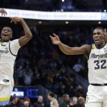 
              Marquette's Darryl Morsell (32) and Kameron Jones (1) celebrate after the team's 67-66 win over Illinois in an NCAA college basketball game Monday, Nov. 15, 2021, in Milwaukee. (AP Photo/Aaron Gash)
            