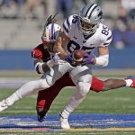 
              Kansas State wide receiver Kade Warner (85) is tackled by Kansas safety Ricky Thomas Jr. (3) during the first half of an NCAA football basketball game against Kansas Saturday, Nov. 6, 2021, in Lawrence, Kan. (AP Photo/Charlie Riedel)
            