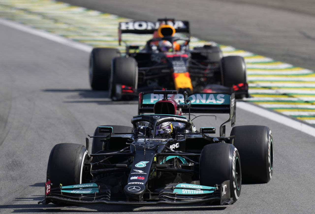 Mercedes' Lewis Hamilton, front, steers his car followed by Red Bull's Max Verstappen , during the ...
