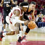 
              Arkansas guard Chris Lykes (11) drives past Pennsylvania guard Jelani Williams (5) on a fast break during the first half of an NCAA college basketball game Sunday, Nov. 28, 2021, in Fayetteville, Ark. (AP Photo/Michael Woods)
            