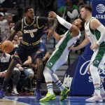
              Denver Nuggets forward JaMychal Green (0) fouls Dallas Mavericks' Jalen Brunson, center, as he works to the basket against Brunson and Luka Doncic, right, in the first half of an NBA basketball game in Dallas, Monday, Nov. 15, 2021. (AP Photo/Tony Gutierrez)
            