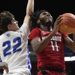 
              North Carolina State's Jaylon Gibson (11) looks to shoot as Central Connecticut State's Trenton McLaughlin (22) defends in the first half of an NCAA college basketball game, Tuesday, Nov. 16, 2021, in Uncasville, Conn. (AP Photo/Jessica Hill)
            