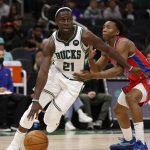 
              Milwaukee Bucks guard Jrue Holiday (21) drives against Detroit Pistons guard Saben Lee (38) during the second half of an NBA basketball game Wednesday, Nov. 24, 2021, in Milwaukee. (AP Photo/Jeffrey Phelps)
            