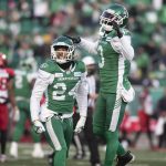 
              Saskatchewan Roughriders defensive back Damon Webb (24) and teammate Nick Marshall (3) celebrate after a referee makes a call in their favor during the first half of a CFL football game against the Calgary Stampeders Sunday, Nov. 28., 2021 in Regina, Saskatchewan. (Kayle Neis/The Canadian Press via AP)
            