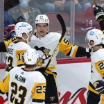 
              Pittsburgh Penguins' Danton Heinen (53) celebrates a goal against the Montreal Canadiens with teammates Brock McGinn, Zach Aston-Reese and Marcus Pettersson during second-period NHL hockey action in Montreal, Thursday, Nov. 18, 2021. (Paul Chiasson/The Canadian Press via AP)
            