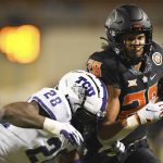 
              TCU safety Nook Bradford (28) tackles Oklahoma State wide receiver Blaine Green (28) during an NCAA college football game Saturday, Nov. 13, 2021, in Stillwater, Okla. (AP Photo/Brody Schmidt)
            