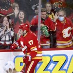 
              Calgary Flames' Milan Lucic and fans celebrate his goal against the Pittsburgh Penguins during the second period of an NHL hockey game, Monday, Nov. 29, 2021 in Calgary, Alberta. (Larry MacDougal/The Canadian Press via AP)
            