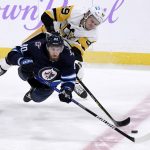 
              Winnipeg Jets' Pierre-Luc Dubois (80) and Pittsburgh Penguins' Jake Guentzel (59) vie for the puck during the first period of an NHL hockey game Monday, Nov. 22, 2021, in Winnipeg, Manitoba. (Fred Greenslade/The Canadian Press via AP)
            