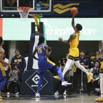 
              West Virginia forward Jalen Bridges (11) shoots while defended by Pittsburgh forward Mouhamadou Gueye (15) during the first half of an NCAA college basketball game in Morgantown, W.Va., Friday, Nov. 12, 2021. (AP Photo/Kathleen Batten)
            