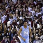 
              North Carolina's Kerwin Walton (24) goes up the court as College of Charleston fans cheer a play during the first half of an NCAA college basketball game Tuesday, Nov. 16, 2021, in Charleston, S.C. (AP Photo/Mic Smith)
            