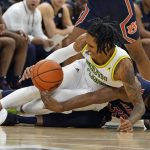 
              South Florida guard Javon Greene (1) and Auburn guard Devan Cambridge (35) battle for a loose ball during the first half of an NCAA college basketball game Friday, Nov. 19, 2021, in Tampa, Fla. (AP Photo/Chris O'Meara)
            