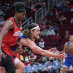 
              Detroit Pistons forward Kelly Olynyk, right, tries to save the ball from going out of bounds as Houston Rockets forward Danuel House Jr. defends during the first half of an NBA basketball game Wednesday, Nov. 10, 2021, in Houston. (AP Photo/Eric Christian Smith)
            