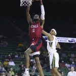 
              Nicholls State guard Latrell Jones (11) scores against Baylor guard James Akinjo, right, in the first half of an NCAA college basketball game, Monday, Nov. 15, 2021, in Waco, Texas. (AP Photo/Rod Aydelotte)
            