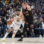 
              Denver Nuggets guard Austin Rivers, left, drives past Miami Heat guard Duncan Robinson in the second half of an NBA basketball game Monday, Nov. 8, 2021, in Denver. The Nuggets won 113-96. (AP Photo/David Zalubowski)
            