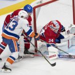 
              Montreal Canadiens goaltender Jake Allen (34) stops New York Islanders' Mathew Barzal (13) as Canadiens' Ben Chiarot (8) moves in during the second period of an NHL hockey game Thursday, Nov. 4, 2021, in Montreal. (Ryan Remiorz/The Canadian Press via AP)
            