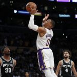 
              Los Angeles Lakers guard Russell Westbrook (0) shoots against San Antonio Spurs forward Thaddeus Young, left, and guard Derrick White during the first half of an NBA basketball game Sunday, Nov. 14, 2021, in Los Angeles. (AP Photo/Alex Gallardo)
            