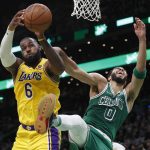 
              Los Angeles Lakers' LeBron James (6) and Boston Celtics' Jayson Tatum (0) battle for a rebound during the first half of an NBA basketball game, Friday, Nov. 19, 2021, in Boston. (AP Photo/Michael Dwyer)
            