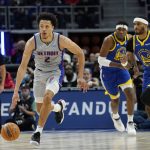 
              Detroit Pistons guard Cade Cunningham (2) brings the ball up court during the first half of an NBA basketball game against the Golden State Warriors, Friday, Nov. 19, 2021, in Detroit. (AP Photo/Carlos Osorio)
            
