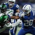
              Indianapolis Colts' Jonathan Taylor (28) runs past New York Jets' C.J. Mosley (57) during the second half of an NFL football game, Thursday, Nov. 4, 2021, in Indianapolis. (AP Photo/Michael Conroy)
            