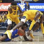 
              Pittsburgh guard Femi Odukale, bottom, is defended by West Virginia guard Malik Curry (10) and forward Dimon Carrigan (5) during the first half of an NCAA college basketball game in Morgantown, W.Va., Friday, Nov. 12, 2021. (AP Photo/Kathleen Batten)
            