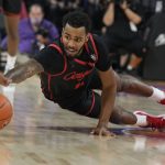 
              Houston guard Kyler Edwards dives for the loose ball against Oregon in the first half during an NCAA college basketball game at the Maui Invitational in Las Vegas, Wednesday, Nov. 24, 2021. (AP Photo/Rick Scuteri)
            