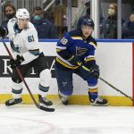 
              St. Louis Blues' Scott Perunovich (48) looks to pass the puck while San Jose Sharks' Santeri Hatakka (61) defends during the second period of an NHL hockey game, Thursday, Nov. 18, 2021, in St. Louis. (AP Photo/Scott Kane)
            