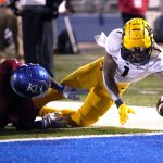 
              West Virginia wide receiver Winston Wright Jr. (1) dives into the end zone for a touchdown against Kansas safety Kenny Logan Jr. (1) during the second quarter of an NCAA college football game Saturday, Nov. 27, 2021, in Lawrence, Kan. (AP Photo/Ed Zurga)
            