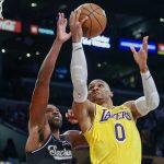
              Los Angeles Lakers guard Russell Westbrook (0) goes to basket whole defended by Sacramento Kings forward Tristan Thompson (13) during the first half of an NBA basketball game in Los Angeles, Friday, Nov. 26, 2021. (AP Photo/Ringo H.W. Chiu)
            