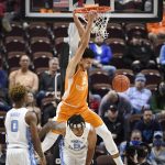 
              Tennessee's Olivier Nkamhoua (13) dunks over North Carolina's Armando Bacot (5) in the second half of an NCAA college basketball game, Sunday, Nov. 21, 2021, in Uncasville, Conn. (AP Photo/Jessica Hill)
            