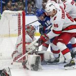 
              Tampa Bay Lightning's Ondrej Palat (18) of Czech Republic, battles against Carolina Hurricanes' Teuvo Teravainen (86), of Finland, for a puck under the pad of goaltender Frederik Andersen, of Denmark, during the second period of an NHL hockey game Tuesday, Nov. 9, 2021, in Tampa, Fla. (AP Photo/Mike Carlson)
            