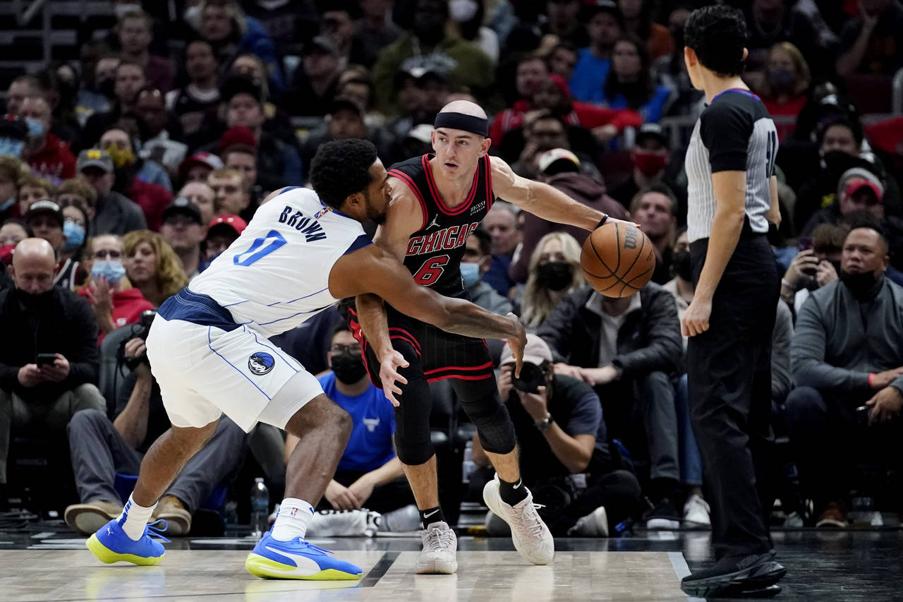 Chicago Bulls guard Alex Caruso (6) is defended by Dallas Mavericks forward Sterling Brown during t...