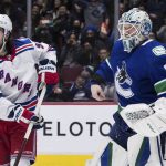 
              Vancouver Canucks goalie Thatcher Demko (35) loses his blocker and stick as he and New York Rangers' Mika Zibanejad follow the play during the third period of an NHL hockey game Tuesday, Nov. 2, 2021, in Vancouver, British Columbia. (Darryl Dyck/The Canadian Press via AP)
            