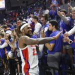 
              Florida guard Brandon McKissic (23) celebrates with fans after an NCAA college basketball game against Troy, Sunday, Nov. 28, 2021, in Gainesville, Fla. (AP Photo/Matt Stamey)
            