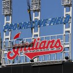 
              Workers begin to remove the Cleveland Indians sign from above the scoreboard at Progressive Field, Tuesday, Nov. 2, 2021, in Cleveland. Known as the Indians since 1915, Cleveland's Major League Baseball team will be called Guardians. (AP Photo/Ron Schwane)
            