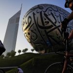 
              Bicyclists ride past the Museum of the Future and Emirates Towers in Dubai, United Arab Emirates, Friday, Nov. 5, 2021. The annual Dubai Ride saw authorities shut down the skyscraper-lined super highway that cuts through the center of the city-state to allow bicyclists to ride on it. Organizers say 32,750 people took part in the ride Friday. (AP Photo/Jon Gambrell)
            