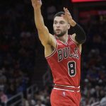 
              Chicago Bulls guard Zach LaVine (8) passes the ball after driving through the lane during the first half of an NBA basketball game against the Orlando Magic, Friday, Nov. 26, 2021, in Orlando, Fla. (AP Photo/Phelan M. Ebenhack)
            